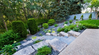 Stone steps to a garden with landscaping. Photo